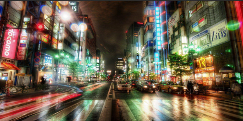 A picture taken of moving cars and neon lights at night